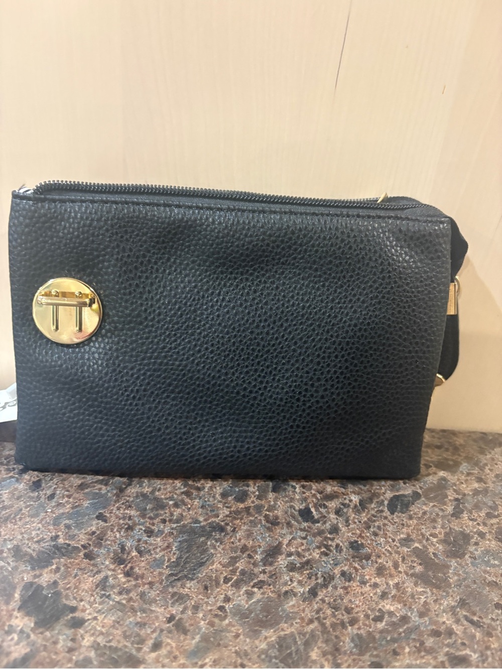 Black Pebbled Leather Crossbody Bag with Gold Emblem